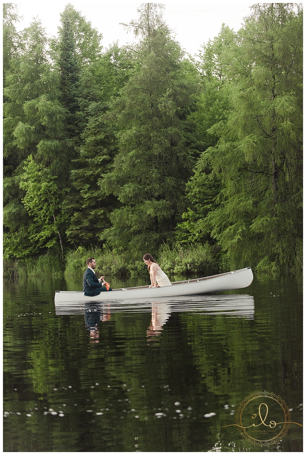 bride and groom in a canoe blue navy gold wedding